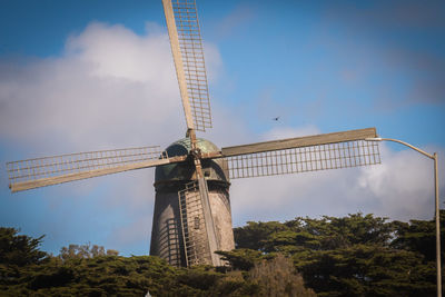 Low angle view of crane against sky