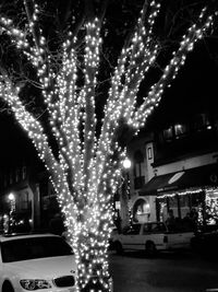 Cars on illuminated street at night