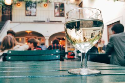 Reflection of restaurant in wineglass