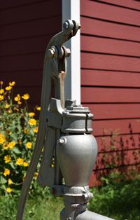 Close-up of metal pipe against building in yard