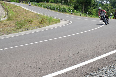 Man riding bicycle on road