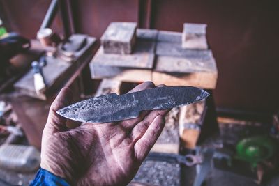 Cropped image of blacksmith holding tool