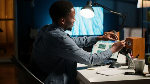 Side view of man working at table