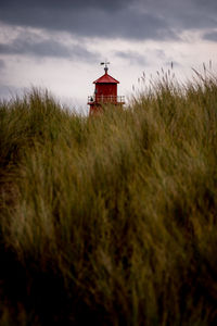 View of lighthouse on field against sky