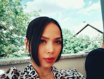 Portrait of woman against plants