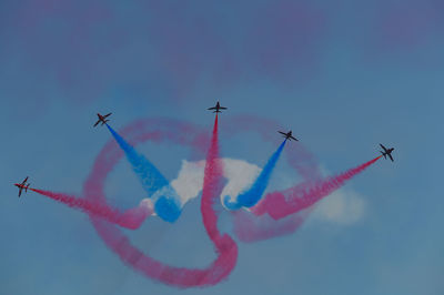 Low angle view of airshow against clear sky