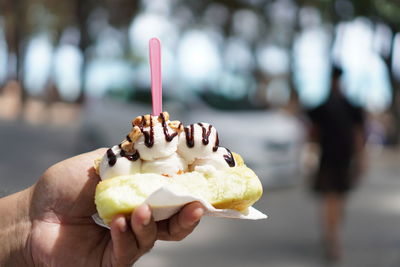 Cropped image of hand holding ice cream