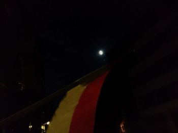 Low angle view of illuminated building against sky at night