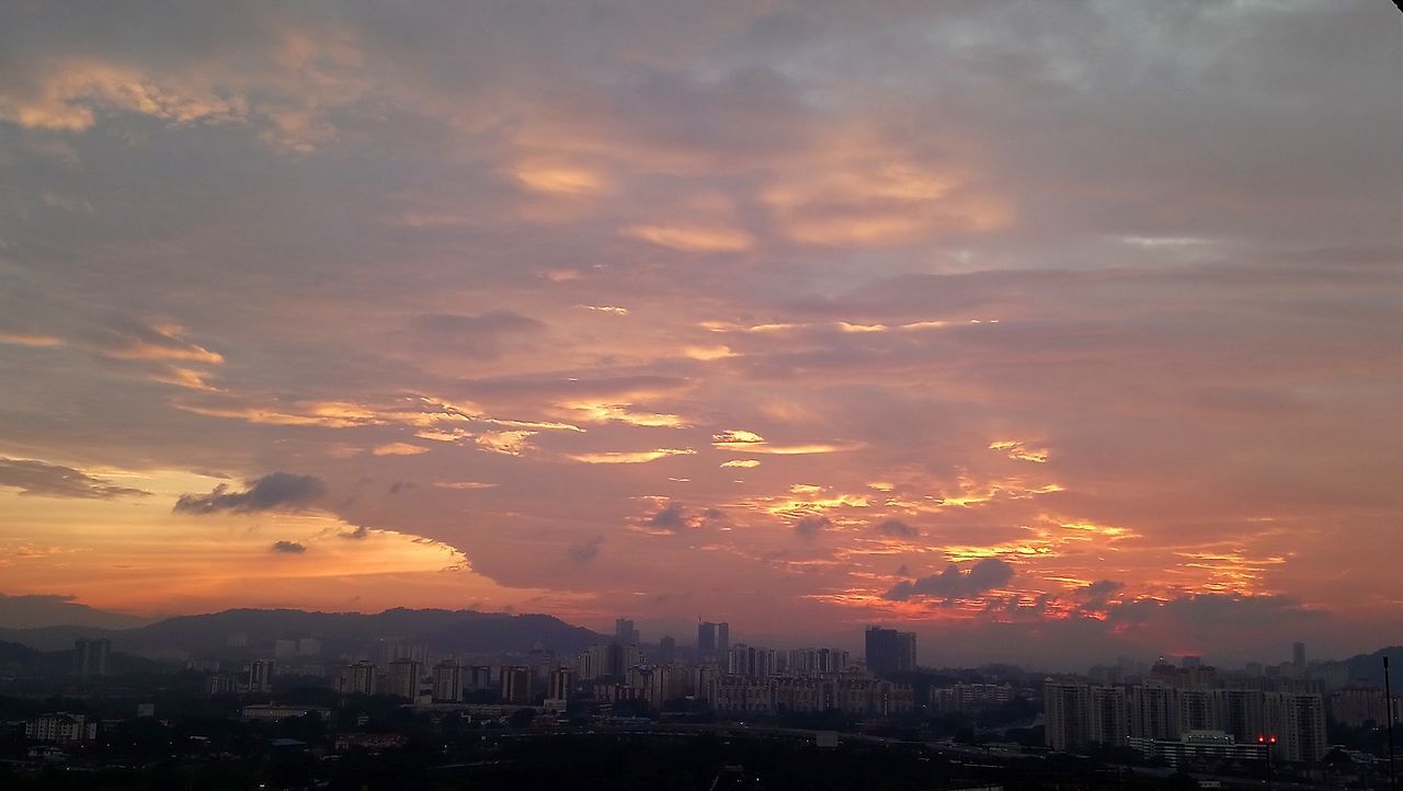 AERIAL VIEW OF BUILDINGS AGAINST DRAMATIC SKY