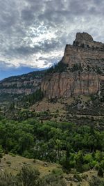 Scenic view of rocky mountains against cloudy sky