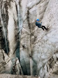 Full length of man climbing on rock