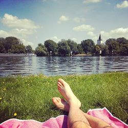 Low section of person relaxing in lake