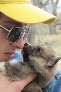 Close-up of young man pampering puppy