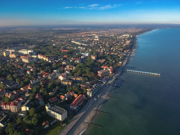 High angle view of sea and buildings against sky