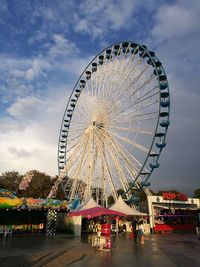 Low angle view of ferris wheel against sky