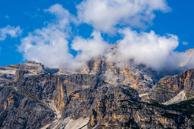 The peaks of the dolomites covered by clouds around the town of cortina d'ampezzo, belluno, italy