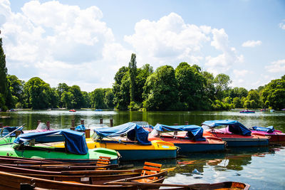 Boats moored in lake against sky