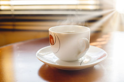 Close-up of coffee cup on table