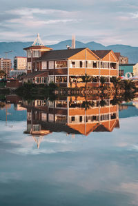 Buildings by sea against sky in city