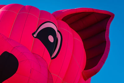 Low angle view of hot air balloon against blue sky