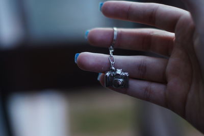 Close-up of hand holding jewelry