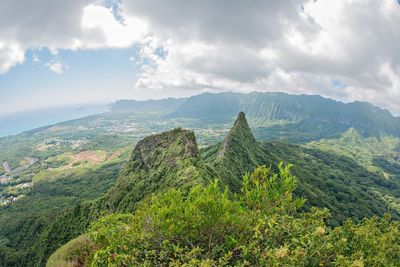 Scenic view of mountains against cloudy sky