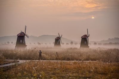 Scenic view of field against sky during sunset