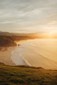 Scenic view of land against sky during sunset