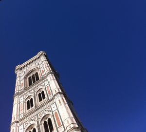 Low angle view of built structure against clear blue sky