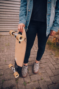 Low section of man standing on footpath