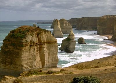 Scenic view of cliff by sea