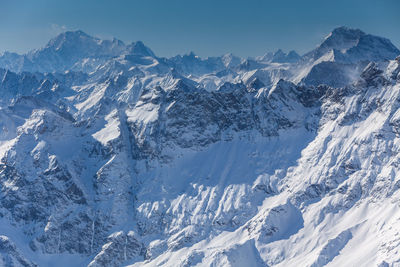 Aerial view of snowcapped mountains against sky