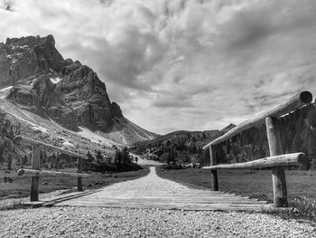 Road by mountain against sky