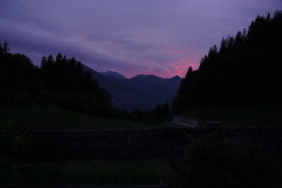 Scenic view of silhouette mountains against sky at night