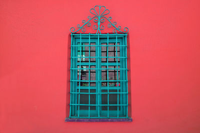 Close-up of window on red wall