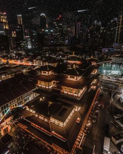 High angle view of illuminated buildings in city at night