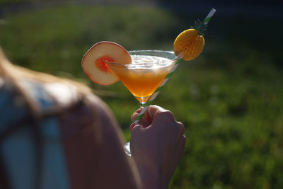 Midsection of man holding wineglass