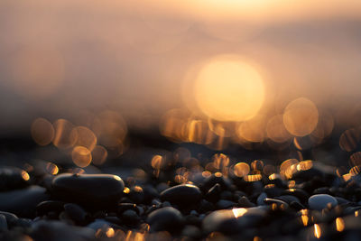 Close-up of pebbles at sunset