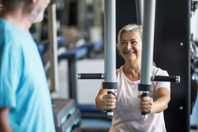 Smiling woman with arms raised