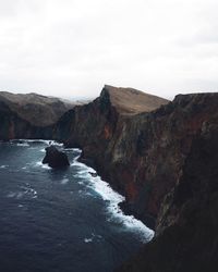 Scenic view of sea and mountains against sky