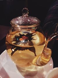 Close-up of illuminated candle on table