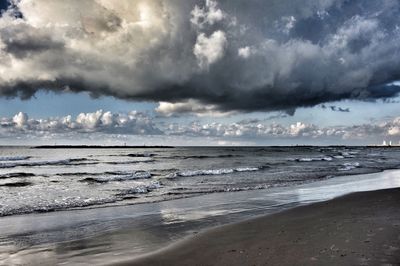Scenic view of sea against storm clouds