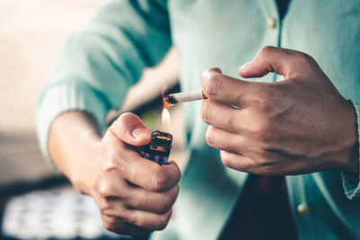 Close-up of man holding cigarette