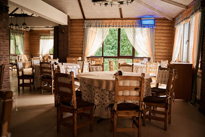 Empty chairs and tables in room