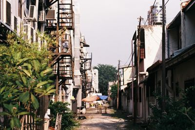 Street amidst buildings against clear sky