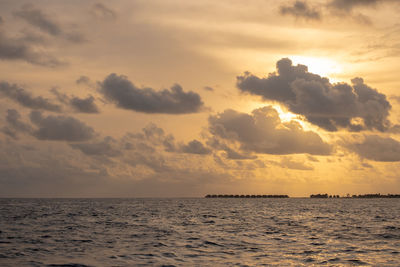 Scenic view of sea against sky at sunset