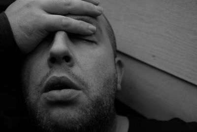 Close-up of tensed man against wall