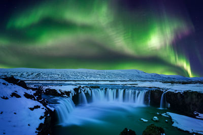 Aurora borealis over godafoss falls at night