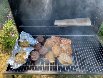 High angle view of meat on barbecue grill