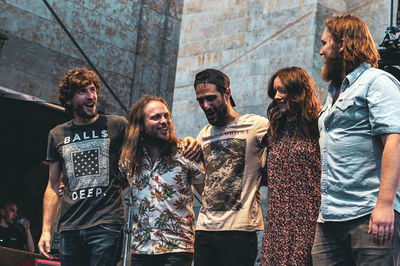 Group of people standing against the wall